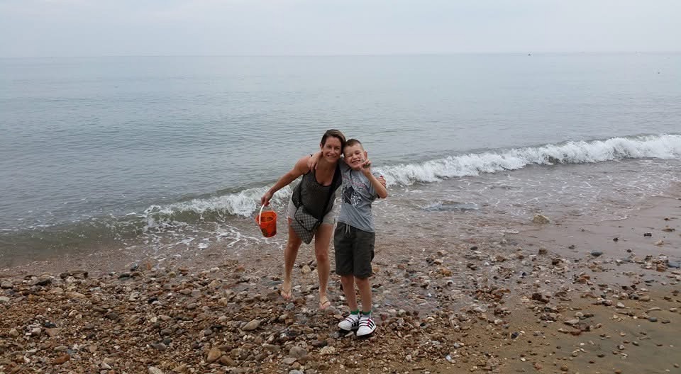 Claire and Harrison fossil hunting on Charmouth beach.