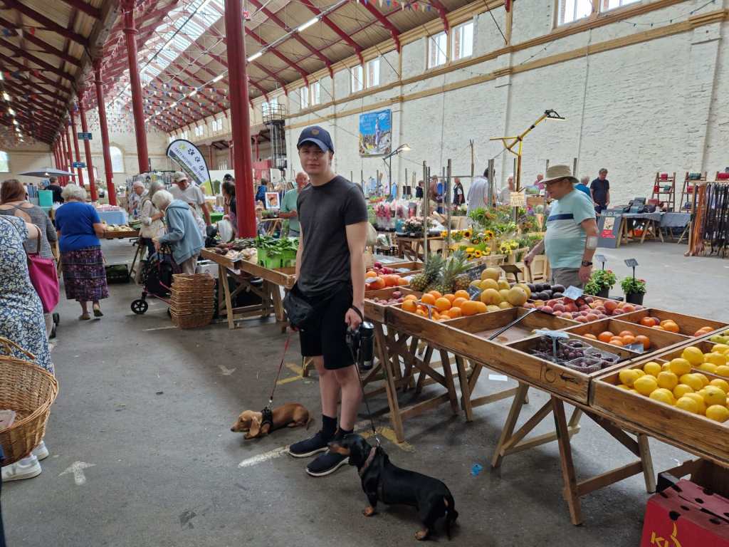 Harrison  and my Dad standing by the fruit and veg stall in the Pannier Market hall.