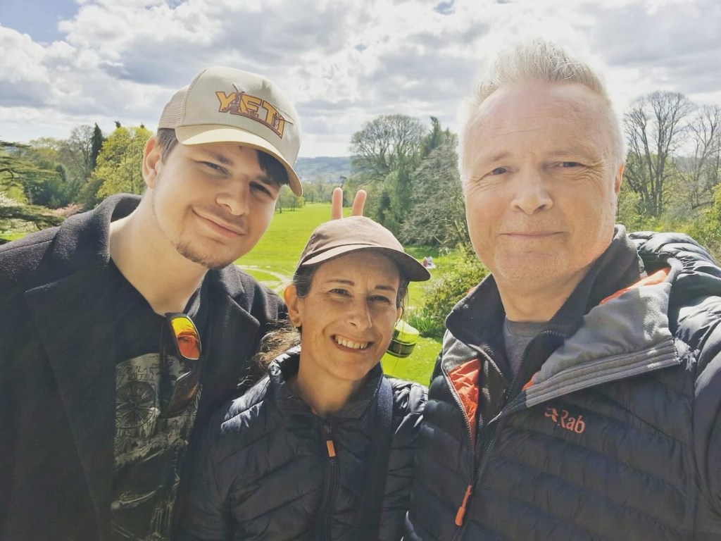 Harrison, Claire and Spencer posing for a selfie with countryside in the background.