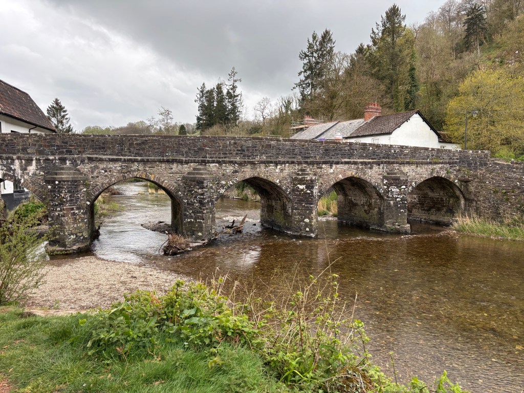 Old stone bridge over shallow river in Dulverton.