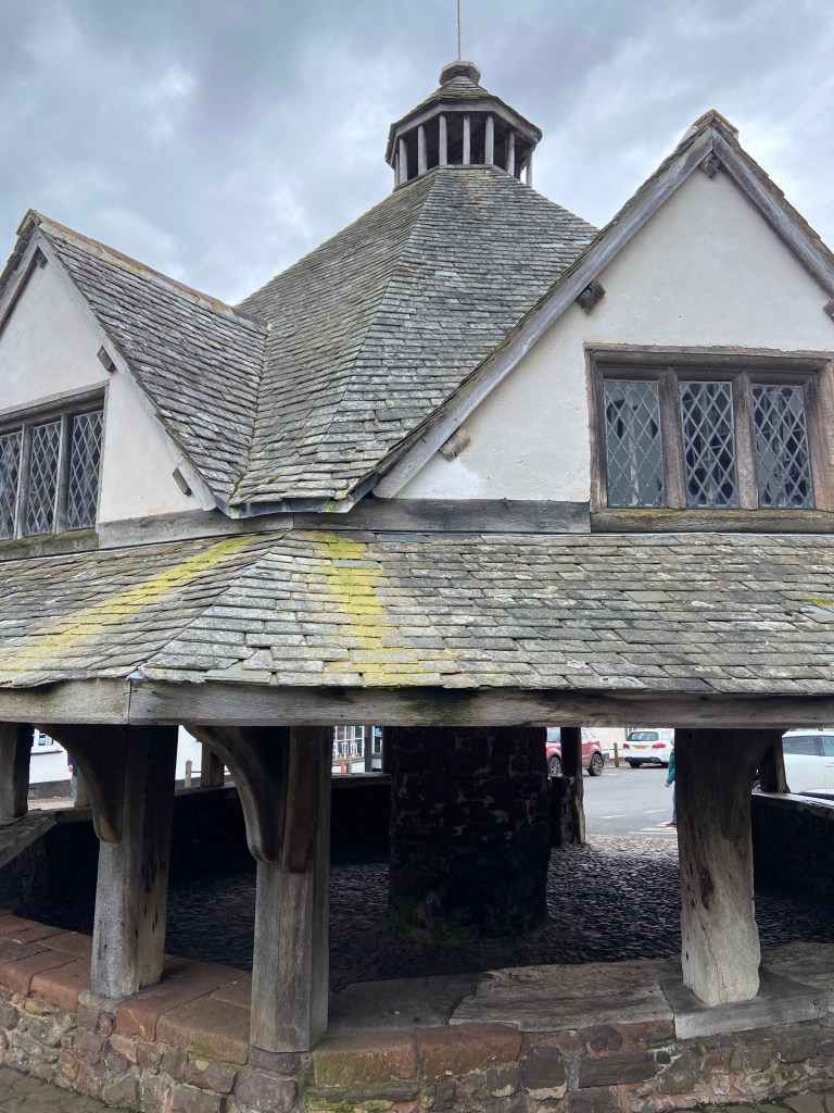 Historic yarn market building with shingle roof and leaded windows.