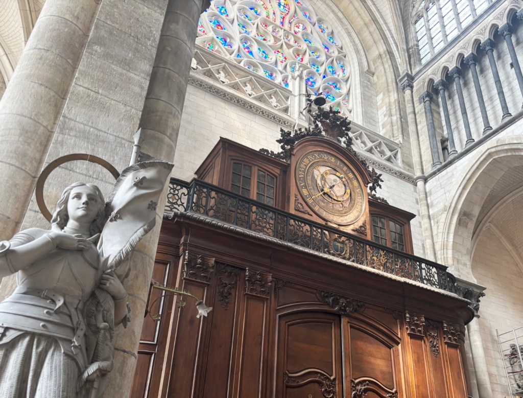 Wooden cabinet containing astrological clock.