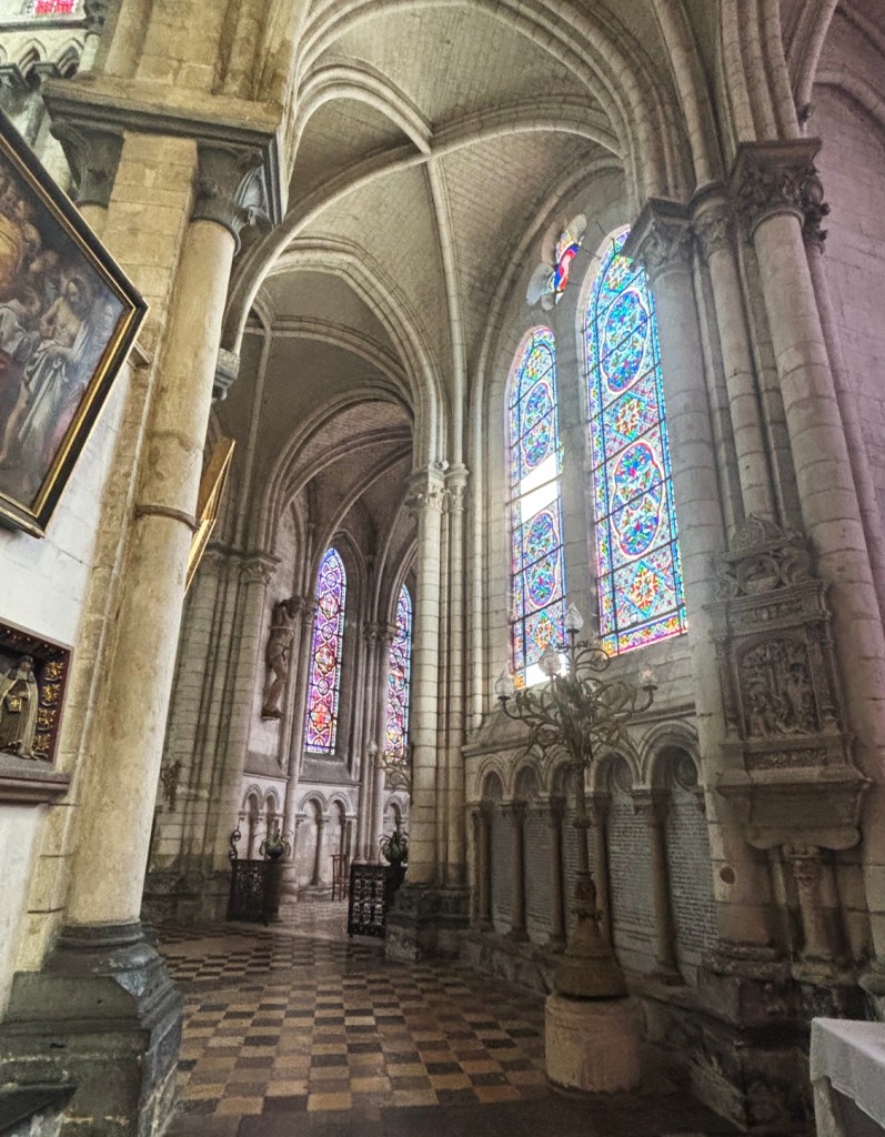 Arching stonework and stained glass windows.